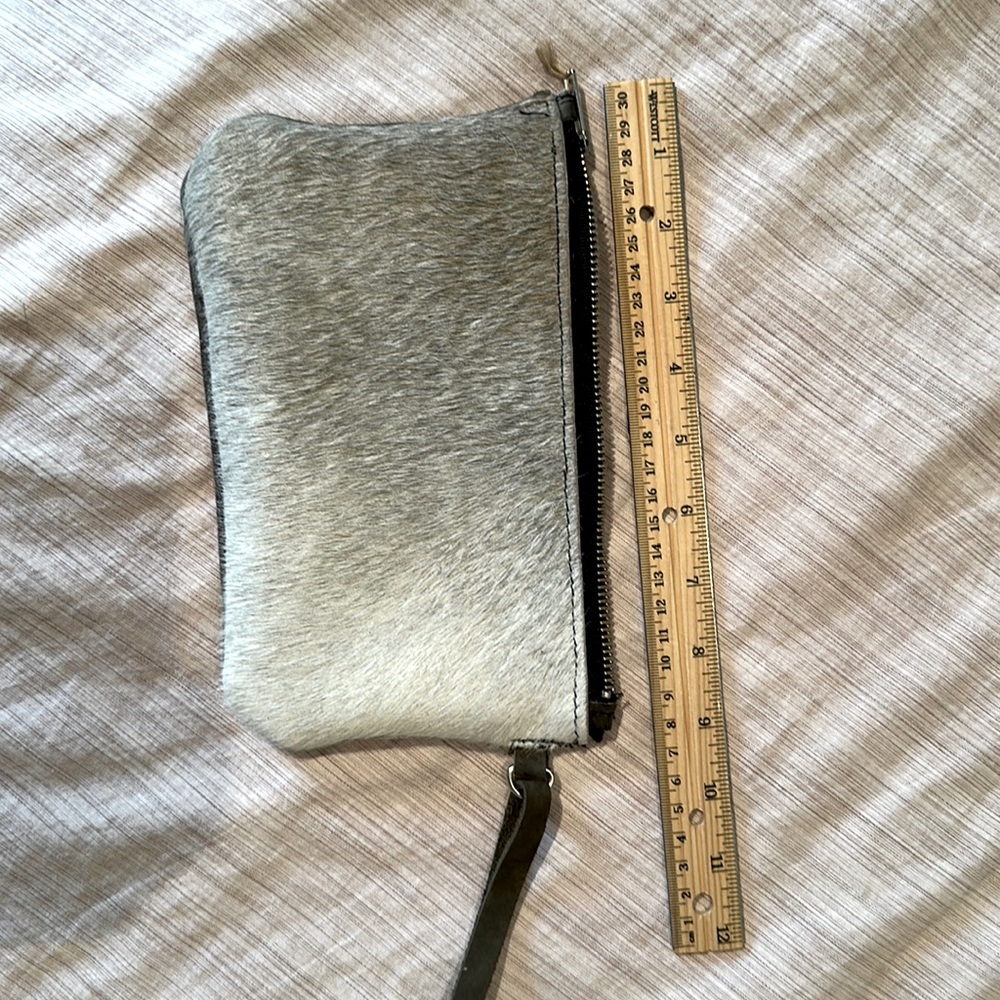 Hair on hide black and white leather clutch dark leather back.